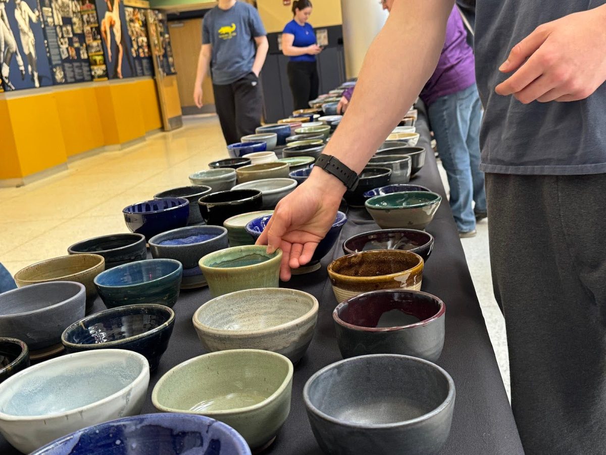 Students choose from a selection of over 500 hand-crafted bowls at the “Empty Bowls” event in the Henderson Campus Center Lobby on Wednesday, April 16. President of Clay Club Eleanor Rochford,’26, stated that the artists in the club had essentially been working on this project since they came back from winter break, hosting a bowl crafting event and then a bowl decorating event over the course of the semester.